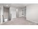 Second-floor hallway with neutral carpet and white doors at 1022 Jeffery Dean Ct, Albemarle, NC 28001