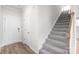 Inviting hallway with hardwood floors leading to carpeted stairs at 1022 Jeffery Dean Ct, Albemarle, NC 28001