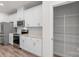 Modern kitchen features white cabinets, stainless steel appliances, granite countertops and wood-look flooring at 1022 Jeffery Dean Ct, Albemarle, NC 28001