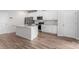 Bright kitchen with stainless steel appliances, a kitchen island, and wood-look floors at 1022 Jeffery Dean Ct, Albemarle, NC 28001