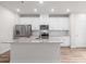 Modern kitchen featuring white cabinets, stainless steel appliances, granite countertops and wood-look flooring at 1022 Jeffery Dean Ct, Albemarle, NC 28001