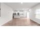 Open living space with wood-look floors, large windows and connecting kitchen featuring stainless appliances at 1022 Jeffery Dean Ct, Albemarle, NC 28001