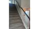 Carpeted staircase with white risers, wood handrail, and view of the living room area at 1022 Jeffery Dean Ct, Albemarle, NC 28001