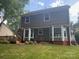 View of the back exterior of the home with a wooden deck and ample yard space at 11021 Scrimshaw Ln, Charlotte, NC 28215