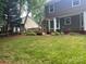 View of the backyard with a wooden deck, lawn and mature trees at 11021 Scrimshaw Ln, Charlotte, NC 28215