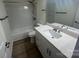 Well-lit bathroom featuring white vanity, granite countertop, and tub-shower combo at 11021 Scrimshaw Ln, Charlotte, NC 28215
