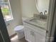 Bathroom with granite counters, round mirror and white cabinets at 11021 Scrimshaw Ln, Charlotte, NC 28215