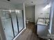 Modern bathroom featuring dual sink vanity and a glass-enclosed shower with white subway tile at 11021 Scrimshaw Ln, Charlotte, NC 28215