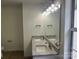 This bathroom has double sinks with granite countertops and lots of mirror lighting at 11021 Scrimshaw Ln, Charlotte, NC 28215