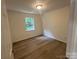 Cozy bedroom featuring wood floors and a window for natural light at 11021 Scrimshaw Ln, Charlotte, NC 28215