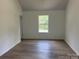 Bedroom featuring hardwood flooring and a window providing natural light at 11021 Scrimshaw Ln, Charlotte, NC 28215