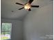 Bedroom with ceiling fan, hardwood flooring, and a window providing natural light at 11021 Scrimshaw Ln, Charlotte, NC 28215