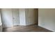 This bedroom features two doors and light wood-look flooring at 11021 Scrimshaw Ln, Charlotte, NC 28215