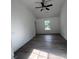 Bright bedroom featuring wood floors and a ceiling fan at 11021 Scrimshaw Ln, Charlotte, NC 28215