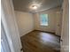 Inviting bedroom featuring wood floors and a window at 11021 Scrimshaw Ln, Charlotte, NC 28215