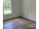 Bedroom with hardwood flooring and one window providing natural light at 11021 Scrimshaw Ln, Charlotte, NC 28215