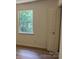 Bedroom with hardwood flooring, one window, and a door leading to the closet at 11021 Scrimshaw Ln, Charlotte, NC 28215