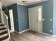 Open foyer with side-lite front door, gray walls and white trim at 11021 Scrimshaw Ln, Charlotte, NC 28215