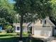 Beautiful home with a well-maintained lawn, mature trees, and a two-car garage at 11021 Scrimshaw Ln, Charlotte, NC 28215