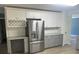 Bright kitchen featuring stainless steel refrigerator, granite countertops, and white cabinets at 11021 Scrimshaw Ln, Charlotte, NC 28215