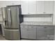 Kitchen area featuring stainless steel refrigerator, granite countertops, and white cabinets at 11021 Scrimshaw Ln, Charlotte, NC 28215
