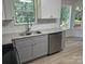 Modern sink featuring stainless steel dishwasher, granite countertops, white cabinets and subway tile backsplash at 11021 Scrimshaw Ln, Charlotte, NC 28215