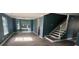 Open-concept living room with many windows for natural light and stairs to the second floor at 11021 Scrimshaw Ln, Charlotte, NC 28215