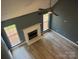 Bright living room with a fireplace, two windows, hardwood floor, and ceiling fan at 11021 Scrimshaw Ln, Charlotte, NC 28215