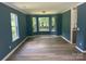 Living room featuring bay window and paint color with seamless access to kitchen at 11021 Scrimshaw Ln, Charlotte, NC 28215