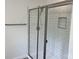 This walk-in shower has white subway tile and a glass door at 11021 Scrimshaw Ln, Charlotte, NC 28215