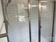 This bathroom includes a shower with white subway tile and a glass door at 11021 Scrimshaw Ln, Charlotte, NC 28215