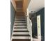 Stairway with neutral walls, and white painted banister and spindles at 11021 Scrimshaw Ln, Charlotte, NC 28215