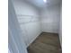 Spacious walk-in closet with wire shelving and wood-look floors offers ample storage at 11021 Scrimshaw Ln, Charlotte, NC 28215