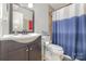 Bathroom with a vanity, sink, toilet, and shower featuring a blue and white shower curtain at 11049 Cedar View Rd, Charlotte, NC 28226