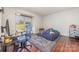 A bright bedroom featuring hardwood floors, a large window, and ample space for relaxation or as a functional office at 11049 Cedar View Rd, Charlotte, NC 28226