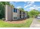 This exterior shows the side of a condo with a well-maintained lawn and features a parking space for residents at 11049 Cedar View Rd, Charlotte, NC 28226