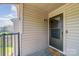 Charming entryway with a glass paneled front door, welcome mat, and outdoor lighting at 11049 Cedar View Rd, Charlotte, NC 28226