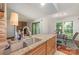 This view of the kitchen features granite countertops, a stainless steel sink and a convenient pass-through to the living area at 11049 Cedar View Rd, Charlotte, NC 28226