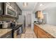 The updated kitchen features stainless steel appliances, granite countertops, and stylish tile backsplash, perfect for cooking at 11049 Cedar View Rd, Charlotte, NC 28226