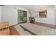 The expansive living room has hardwood floors and glass sliding doors to the balcony providing a seamless indoor-outdoor flow at 11049 Cedar View Rd, Charlotte, NC 28226