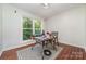 A bright living room features hardwood floors and a large window with views of the yard, perfect for relaxation or entertaining at 11049 Cedar View Rd, Charlotte, NC 28226
