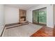 Cozy living room features a brick fireplace and sliding glass doors to a balcony with wooded views at 11049 Cedar View Rd, Charlotte, NC 28226