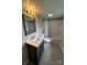 Bathroom with a vanity, mirror, modern lighting, tiled floors, and a shower/tub combination with curtain at 111 Rose St, Mount Holly, NC 28120