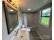 Bathroom featuring a vanity, mirror, modern lighting, tiled floors, and a shower/tub combination at 111 Rose St, Mount Holly, NC 28120