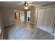 Bedroom featuring wood-look floors, doors to adjacent rooms, and a closet with doors at 111 Rose St, Mount Holly, NC 28120