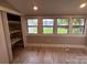 Cozy bedroom with wood-look flooring, natural light and built-in storage at 111 Rose St, Mount Holly, NC 28120