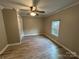 Bedroom showcasing wood-look floors, a ceiling fan, and a window with outside views at 111 Rose St, Mount Holly, NC 28120