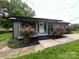 Charming home featuring a covered porch and landscaping with red roses at 111 Rose St, Mount Holly, NC 28120