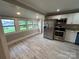 Bright kitchen with stainless steel appliances, white cabinets, and lots of windows at 111 Rose St, Mount Holly, NC 28120