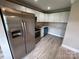 Updated kitchen featuring stainless steel appliances and white cabinets at 111 Rose St, Mount Holly, NC 28120